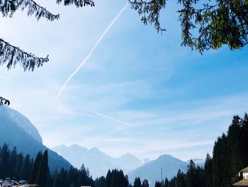 Low angle view of vapor trails against sky