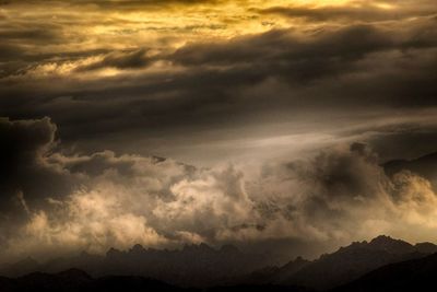 Scenic view of mountains against cloudy sky