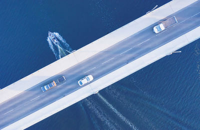 High angle view of cars moving on bridge over sea