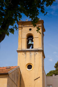 Low angle view of bell tower against sky