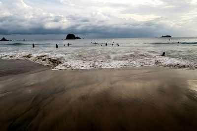 Scenic view of sea against cloudy sky