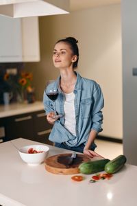 Portrait of young woman sitting on table