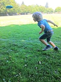 Full length of girl playing on grassy field