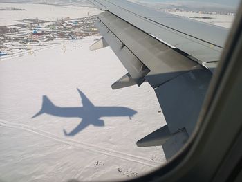 Airplane wing seen through window