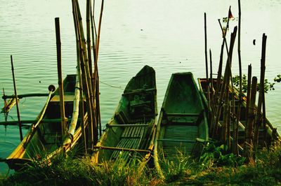 Sailboats moored in lake