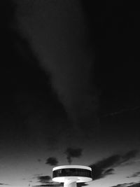 Low angle view of illuminated light against sky at night