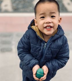 Portrait of cute boy holding ball