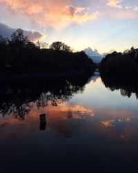 Scenic view of lake against sky at sunset