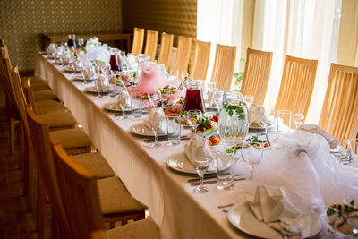 Food and drinks arranged on dining table during wedding