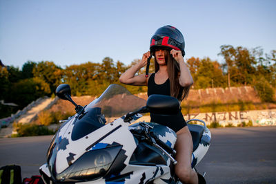 Rear view of man riding motorcycle on road