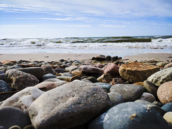 Rocks on beach against sky