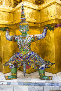 Statue of buddha against building