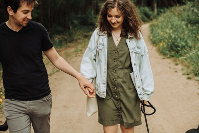 Young couple on first date holding hands while walking down the path