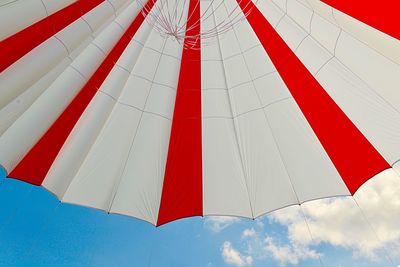 Low angle view of tent hanging against cloudy sky