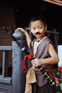 Full length of boy holding camera