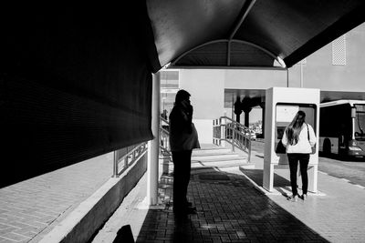 Woman standing on sidewalk