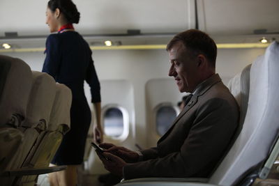 Side view of man sitting in bus