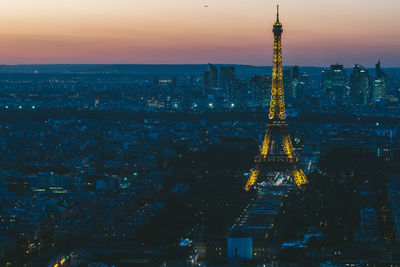 Aerial view of city lit up at sunset