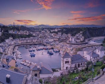 High angle view of townscape by river against sky