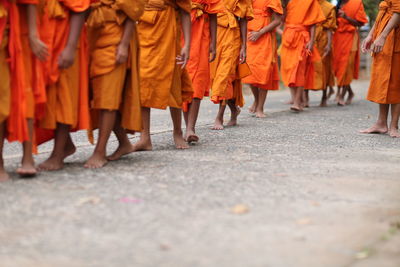 Low section of people standing on street