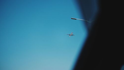 Low angle view of airplane flying in sky