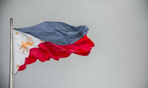 Low angle view of flag against white background