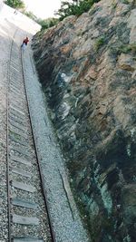 Railroad tracks by river against sky