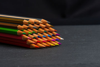 Close-up of multi colored pencils on table