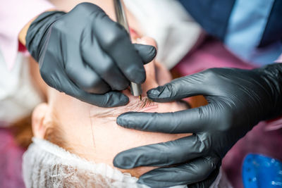 Midsection of female doctor examining patient