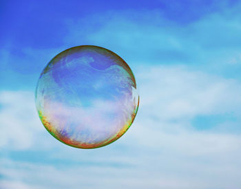 Low angle view of bubbles against sky