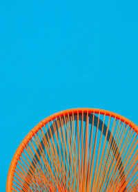 Summer armchair against a blue wall. home decor in detail. minimalist aesthetic