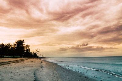 Scenic view of beach against sky during sunset