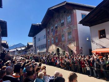 People on street amidst buildings in city