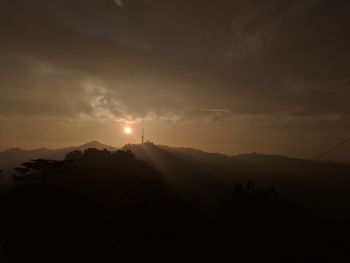 Scenic view of silhouette mountains against sky at sunset