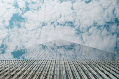 Low angle view of modern building against cloudy sky