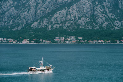 Sailboats in sea by city