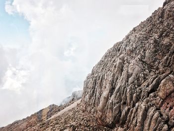 Low angle view of rock formation against sky