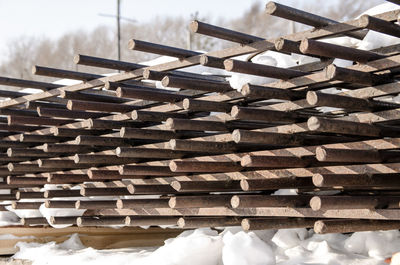 Steel reinforcement for concrete reinforcement stacked in rows.