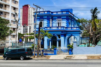 Buildings in city against blue sky