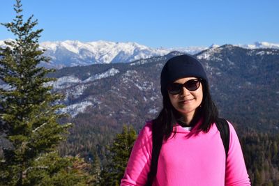 Mid adult man in sunglasses against mountains during winter