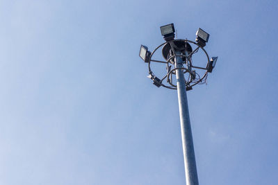 Low angle view of street light against blue sky
