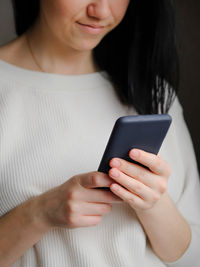 Girl holds a smartphone in her hands. touch screen smartphone, in hand. businesswoman 