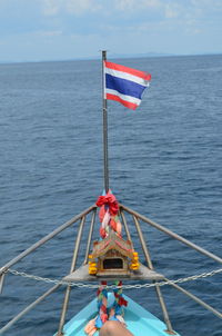 Flag on sea against sky