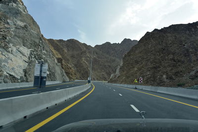 Road amidst mountains against sky