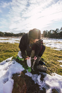 Female ice-skater changing footwear