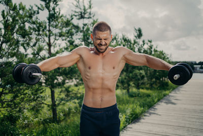 F shirtless man exercising outdoors