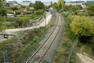 High angle view of railroad tracks amidst trees in city
