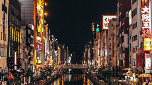 Illuminated canal and buildings at night