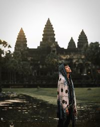 Person standing on temple against sky