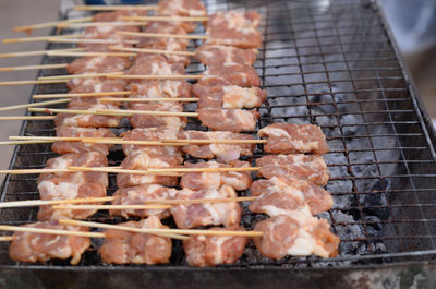 Fresh pork skewered on a charcoal grill, grilled pork, thai street food style